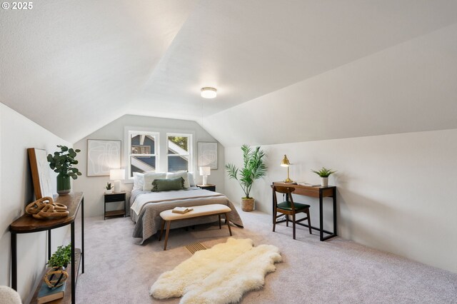 bedroom featuring carpet and lofted ceiling