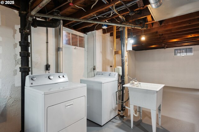 clothes washing area with washer and dryer