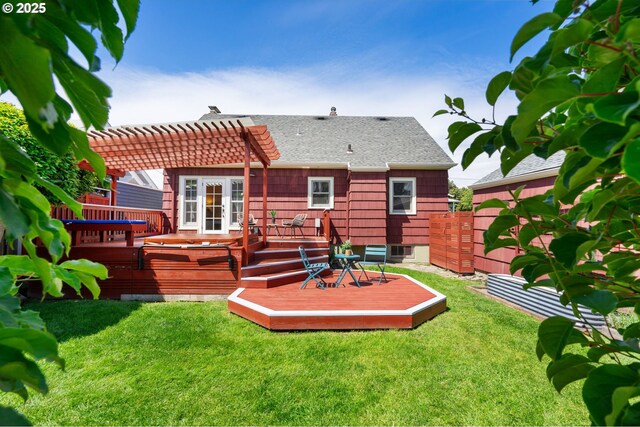 back of property with a pergola, a deck, and roof with shingles