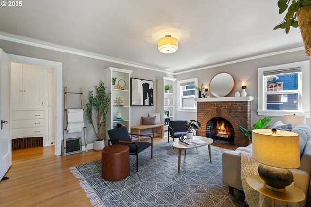 sitting room featuring wood finished floors, a fireplace, and crown molding