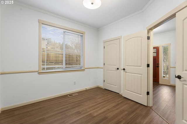 unfurnished bedroom with dark hardwood / wood-style flooring and crown molding