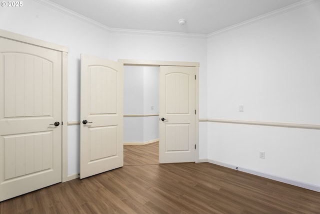 unfurnished bedroom featuring crown molding, a closet, and hardwood / wood-style flooring