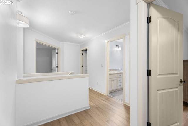 hall featuring light hardwood / wood-style flooring and ornamental molding