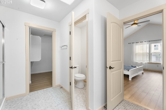 bathroom featuring ceiling fan, hardwood / wood-style floors, lofted ceiling, and toilet