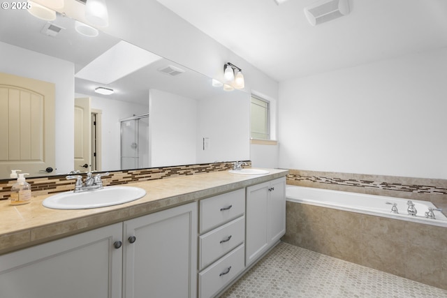 bathroom with tile patterned flooring, shower with separate bathtub, and vanity