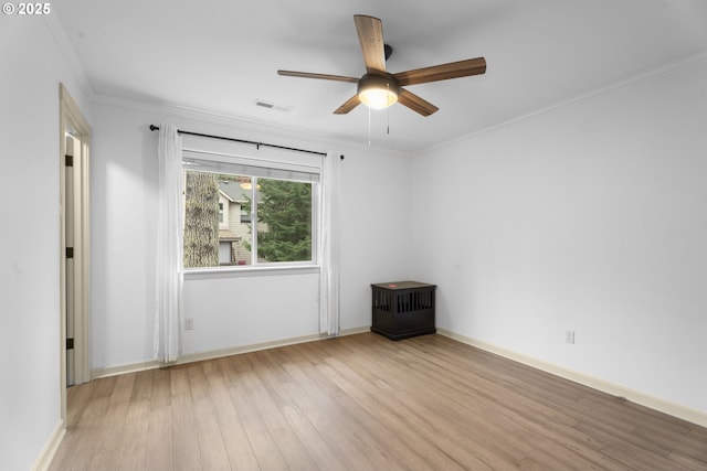 spare room featuring ceiling fan, light hardwood / wood-style floors, and ornamental molding