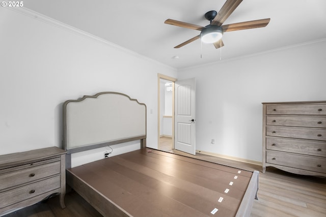 unfurnished bedroom with light wood-type flooring, ceiling fan, and crown molding