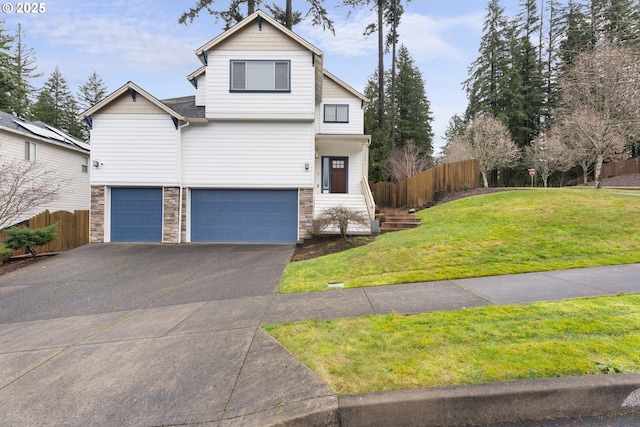 view of front of house featuring a garage and a front lawn