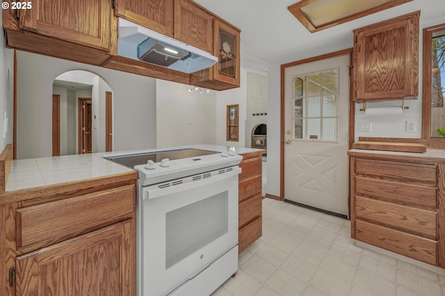 kitchen featuring electric range and tile countertops