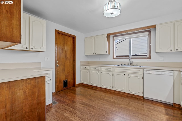 kitchen with sink, light hardwood / wood-style floors, white cabinets, and dishwasher