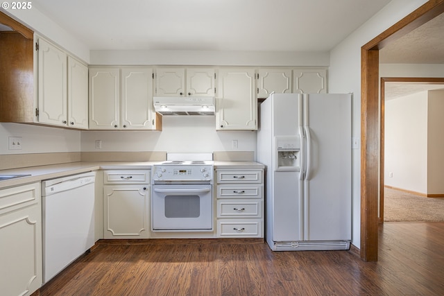 kitchen featuring white appliances, dark hardwood / wood-style flooring, and white cabinets