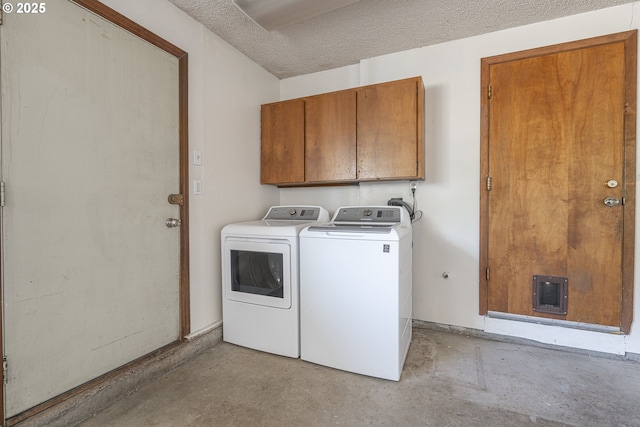 laundry room with cabinets, separate washer and dryer, and a textured ceiling