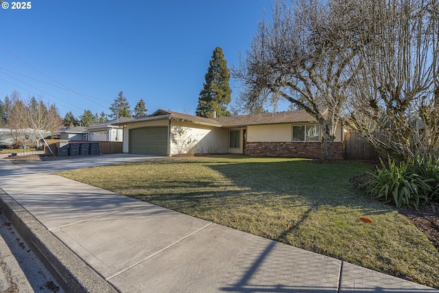 ranch-style house featuring a garage and a front lawn