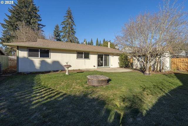 rear view of house featuring a lawn and a patio area