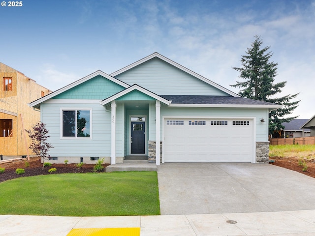 single story home with a garage, crawl space, stone siding, a front lawn, and driveway