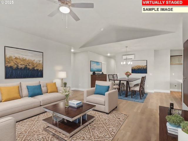 living room with light wood-style flooring, baseboards, vaulted ceiling, and ceiling fan with notable chandelier