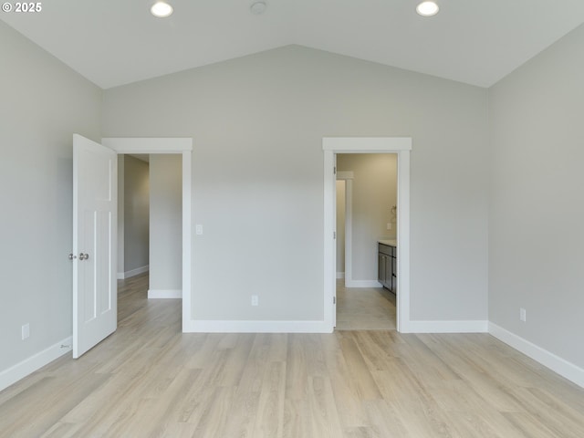 spare room featuring baseboards, light wood-type flooring, recessed lighting, and lofted ceiling