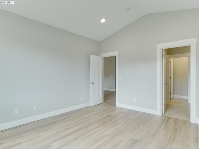 unfurnished bedroom with high vaulted ceiling and light hardwood / wood-style flooring