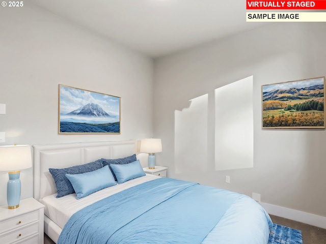 carpeted bedroom featuring baseboards