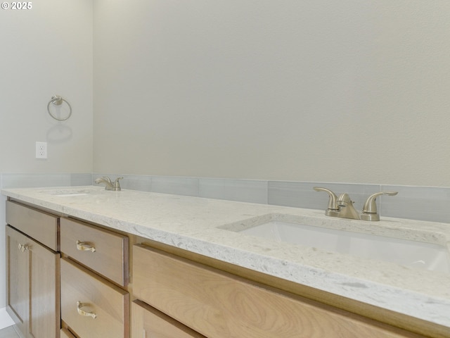 bathroom featuring double vanity and a sink