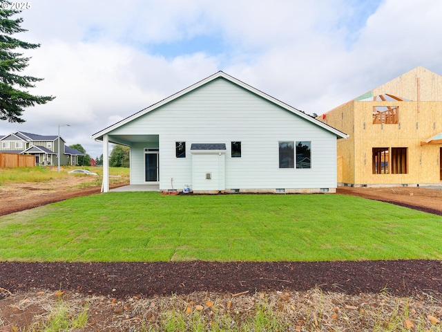 rear view of house featuring a patio area, crawl space, and a lawn