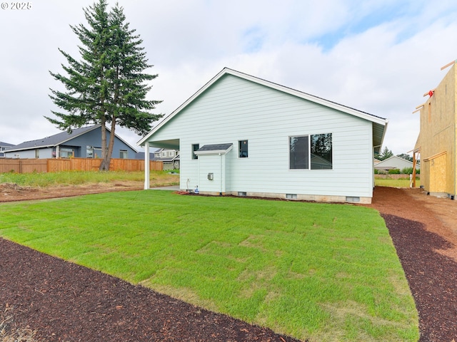 back of house with a yard, fence, and crawl space