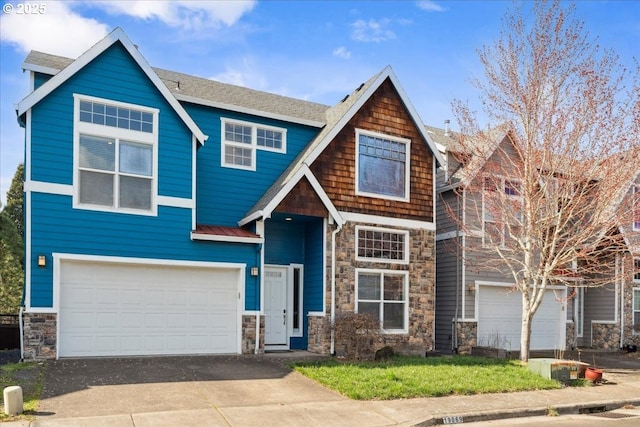 view of front of home featuring stone siding, an attached garage, metal roof, and driveway