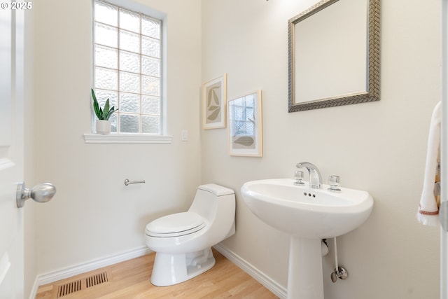 bathroom featuring hardwood / wood-style flooring, sink, and toilet