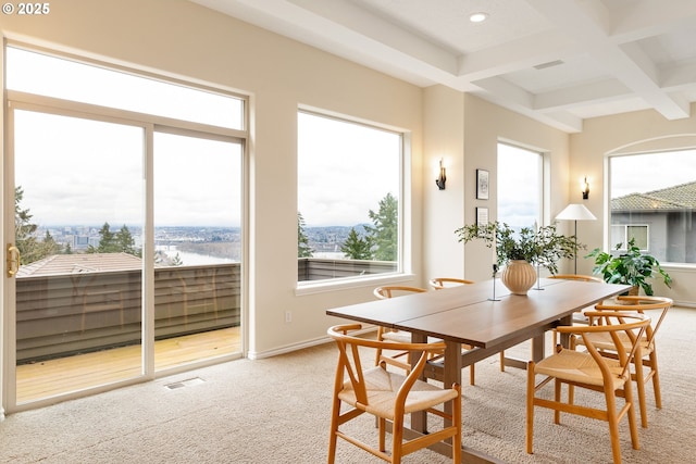 carpeted dining space with beamed ceiling and coffered ceiling