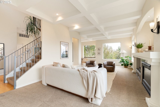 230 SW Florida St, Portland, OR 97219 - carpeted living room featuring coffered ceiling, beamed ceiling, stairway, a glass covered fireplace, and recessed lighting
