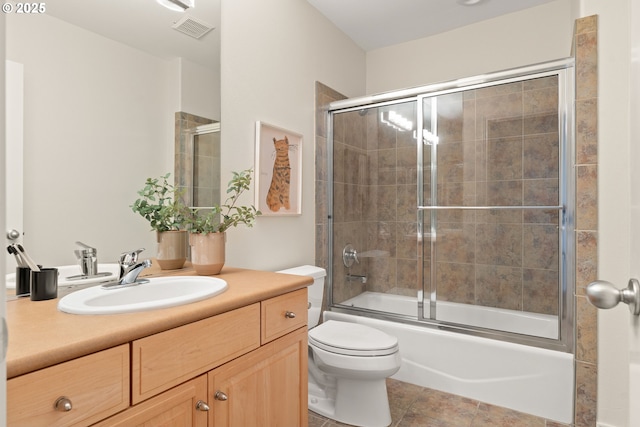 full bathroom with vanity, tile patterned floors, toilet, and combined bath / shower with glass door