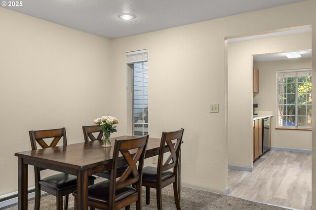 6160 SW Alice Ln Unit 203B, Beaverton, OR 97008 - kitchen with black appliances, brown cabinets, light wood finished floors, and light countertops