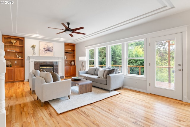 10540 SW Lancaster Rd, Portland, OR 97219 - living area with ceiling fan, healthy amount of natural light, light wood-style flooring, and a tile fireplace