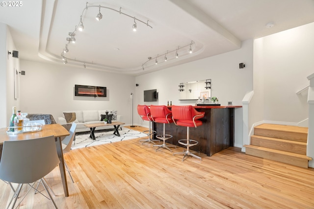 10540 SW Lancaster Rd, Portland, OR 97219 - indoor dry bar with wood finished floors, stairway, track lighting, and baseboards