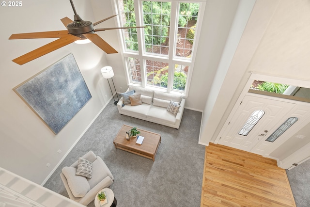 10540 SW Lancaster Rd, Portland, OR 97219 - carpeted living area featuring a ceiling fan, baseboards, and wood finished floors