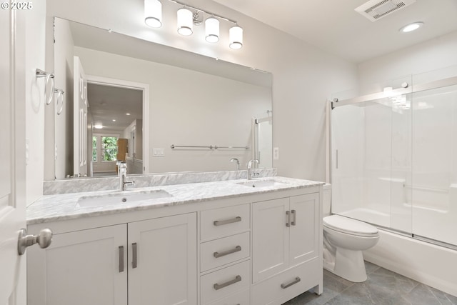 10540 SW Lancaster Rd, Portland, OR 97219 - bathroom featuring double vanity, toilet, enclosed tub / shower combo, and recessed lighting