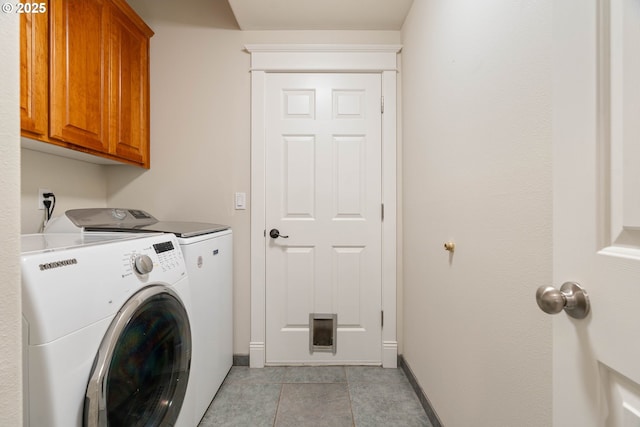 10540 SW Lancaster Rd, Portland, OR 97219 - washroom featuring washing machine and dryer, cabinet space, baseboards, and light tile patterned floors