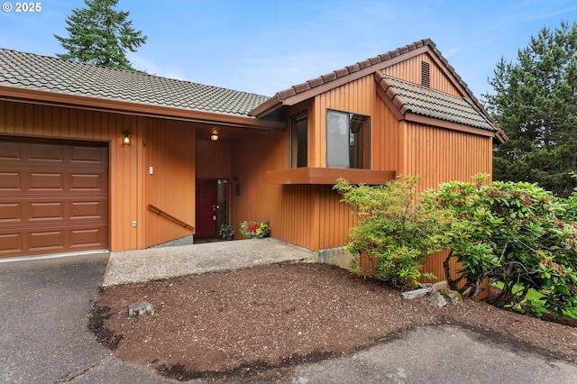 10315 SW 28th Ave, Portland, OR 97219 - view of front of property with a tile roof, a garage, and driveway