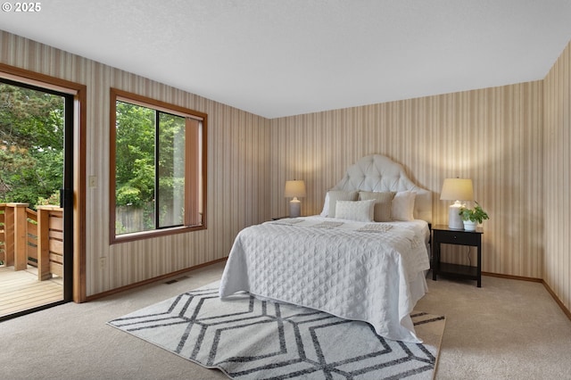 10315 SW 28th Ave, Portland, OR 97219 - bedroom with wallpapered walls, access to outside, light colored carpet, and baseboards