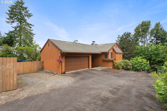 10315 SW 28th Ave, Portland, OR 97219 - view of front of property featuring a tiled roof, a garage, and driveway