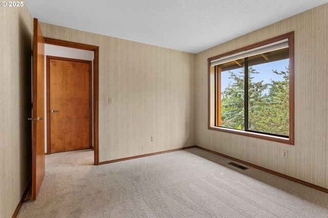 10315 SW 28th Ave, Portland, OR 97219 - spare room featuring carpet floors, wallpapered walls, and baseboards