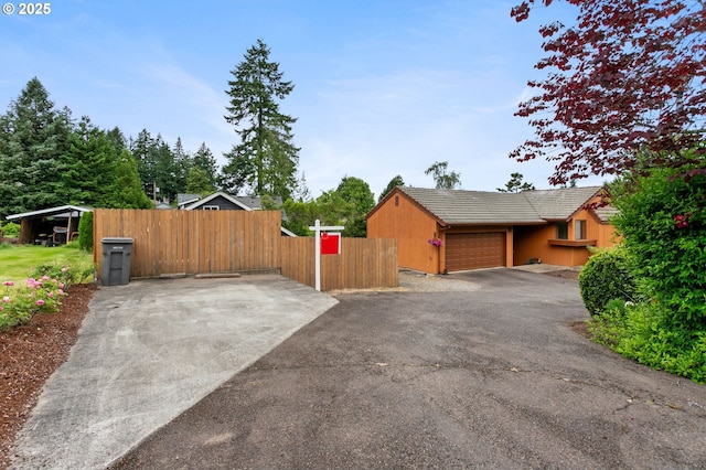 10315 SW 28th Ave, Portland, OR 97219 - view of side of home featuring a garage, asphalt driveway, and a tile roof