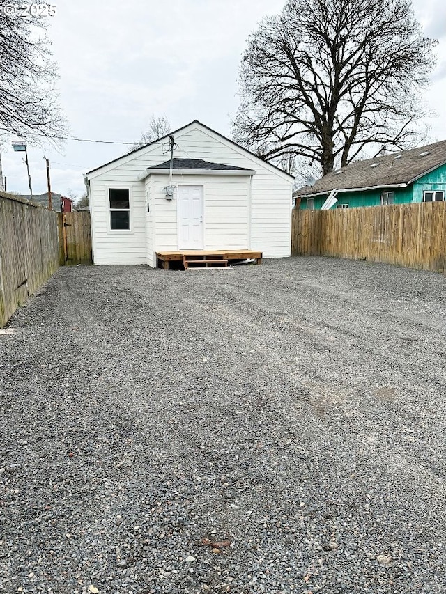 garage with driveway and fence