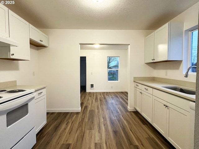 kitchen with a sink, white electric range, dark wood-type flooring, and white cabinetry