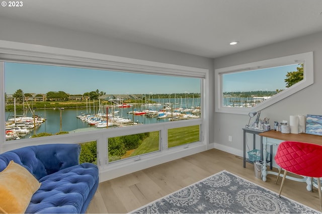 sunroom / solarium featuring a water view