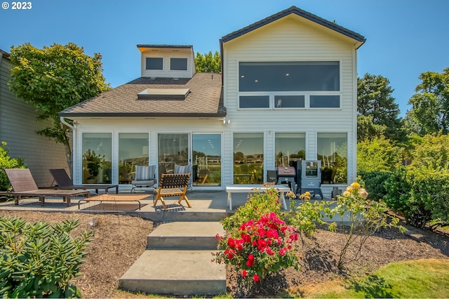 back of property with a patio