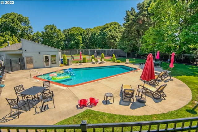 view of pool featuring a patio and a lawn