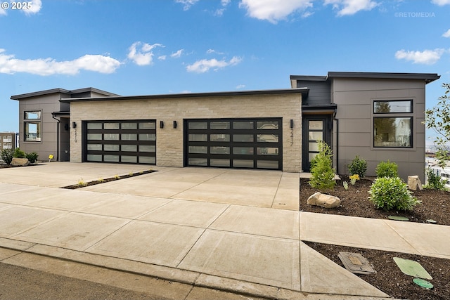 2417 E 6th St, Vancouver, WA 98661 - modern home with driveway, stone siding, and an attached garage