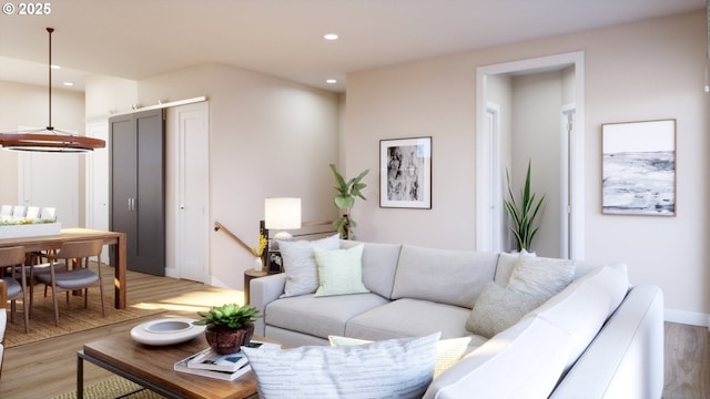 living area featuring baseboards, light wood finished floors, and recessed lighting