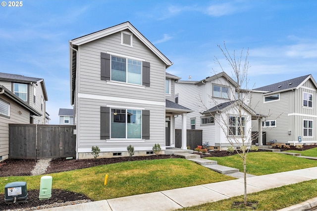 view of front of home featuring a front yard and fence